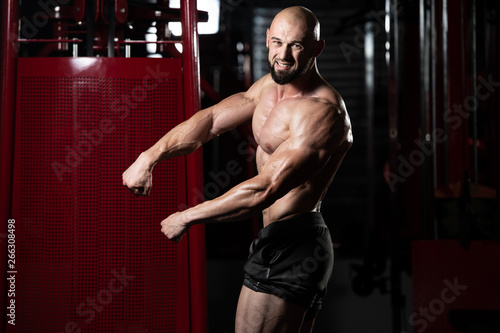 Healthy Young Man Flexing Muscles