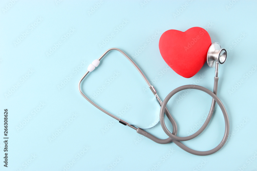 Stethoscope and heart on wooden color background. Health, medicine Stethoscope and heart on wooden color background. Health, medicine