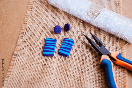Assembly of handmade abstract earrings. Hobby jewelry background.