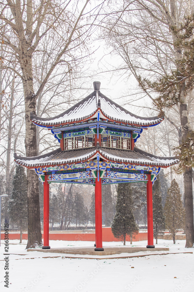 There is a pavilion in the snow in winter