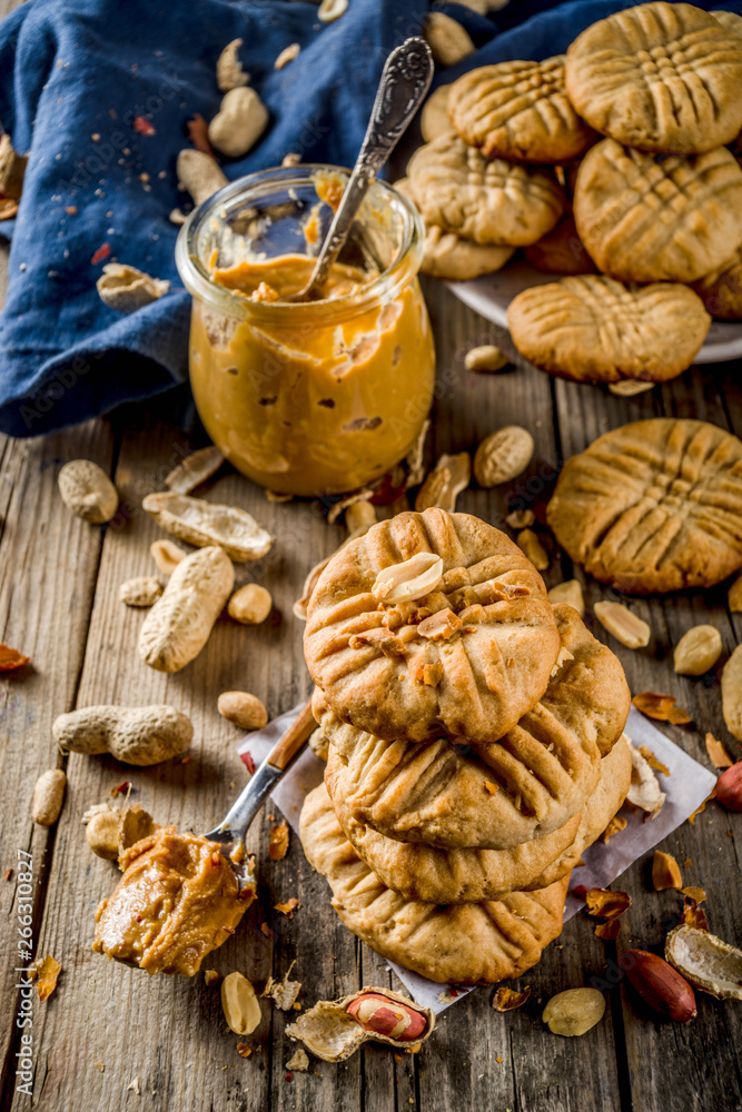 Fototapeta premium Traditional american baking, homemade Peanut Butter Cookies with peanuts and peanut butter on rustic wooden table