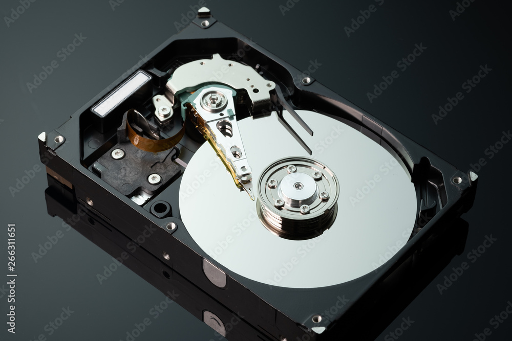 Hard drive from the computer hdd with mirror effect. Close-up, macro, on a black background. Hard drive from the computer hdd with mirror effect. Close-up, macro, on a black background.