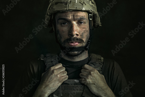 Bleeding injury inside. Close up portrait of young male soldier. Man in military uniform on the war. Depressed and having problems with mental health and emotions, PTSD, rehabilitation.