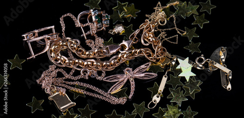 Abstract gold chain, braclet and jewerly on a dark background