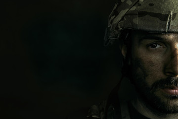 Dark side of me will be closed always. Close up portrait of young male soldier. Man in military uniform on the war. Depressed and having problems with mental health and emotions, PTSD, rehabilitation.