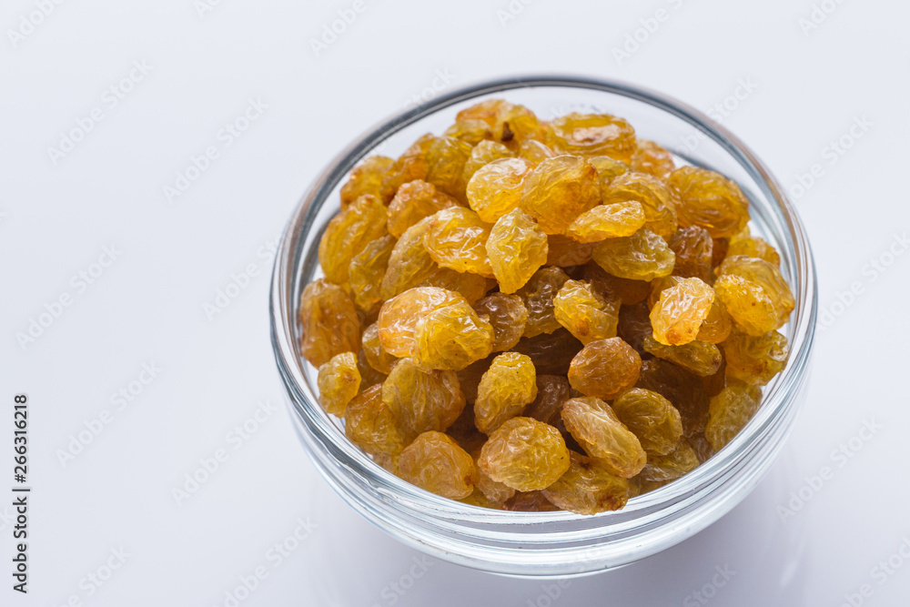 golden raisins on a white acrylic background golden raisins on a white acrylic background