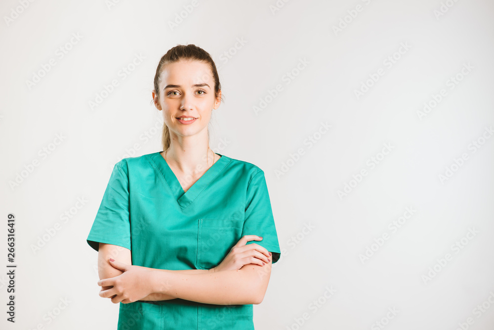 Cheerful female doctor in green uniform. Cheerful female doctor in green uniform.