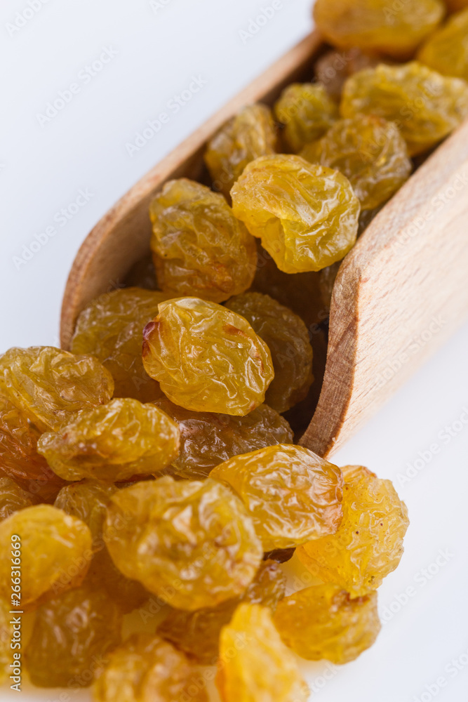 golden raisins on a white acrylic background golden raisins on a white acrylic background