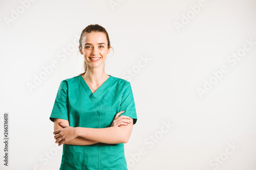 Cheerful female doctor in green uniform. photo