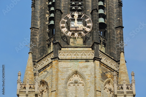 Nieuwe Kerk clock tower: close-up on clock, bells and spires, Delft, Netherlands photo