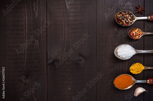 Set of seasonings and spices on wooden brown background