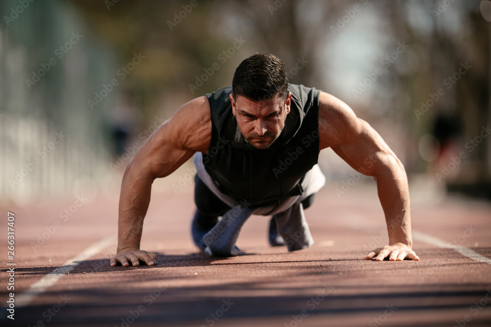 Fitness man doing push ups outdoor Fitness man doing push ups outdoor