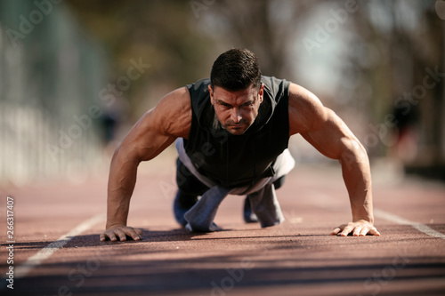Fitness man doing push ups outdoor