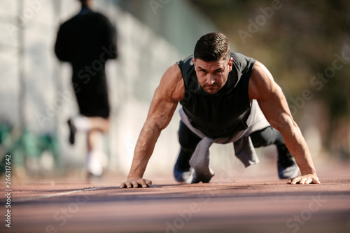 Fitness man doing push ups outdoor. Athlete training.