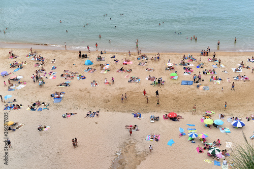 People on the beach of Playa de Matalenas, Cantabria, Santander, Spain © akturer