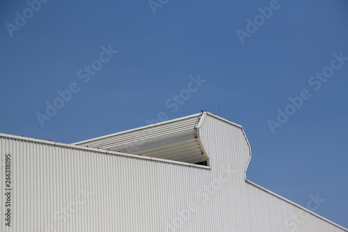 metal factory roof with blue sky background.