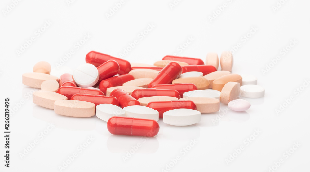 medical red and white pills and capsules with medicine are on a white background