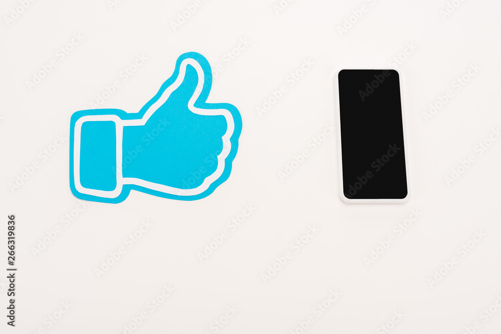 blue thumb up sign near laptop with blank screen isolated on white blue thumb up sign near laptop with blank screen isolated on white