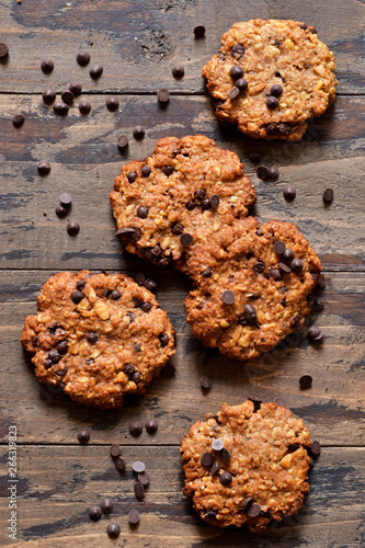 Oatmeal cookies with chocolate drops on a wooden background. View from above.