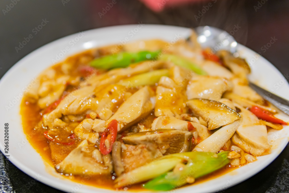 Close up shot of a dish of fried tofu, swim bladder with mushroom Close up shot of a dish of fried tofu, swim bladder with mushroom