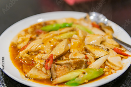 Close up shot of a dish of fried tofu, swim bladder with mushroom
