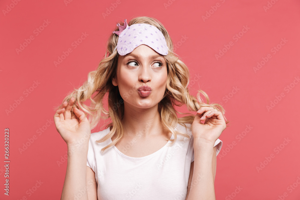 Portrait of seductive young woman 20s wearing sleeping mask smiling on camera after awakening Portrait of seductive young woman 20s wearing sleeping mask smiling on camera after awakening