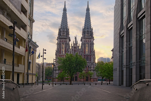 Spring morning landscape view of astonishing Saint Nicholas Roman Catholic Cathedral (House of Organ Music) during sunrise. View of the cathedral between the high-rise buildings. Kyiv, Ukraine © evgenij84