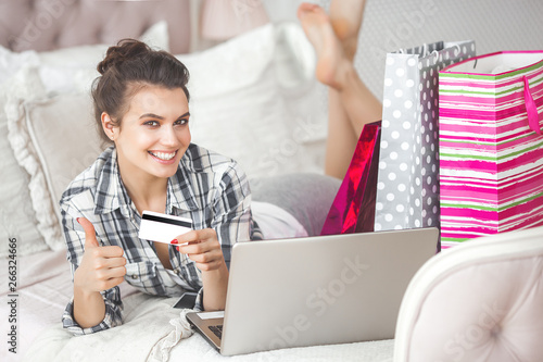 Young attractive woman making online shopping at home