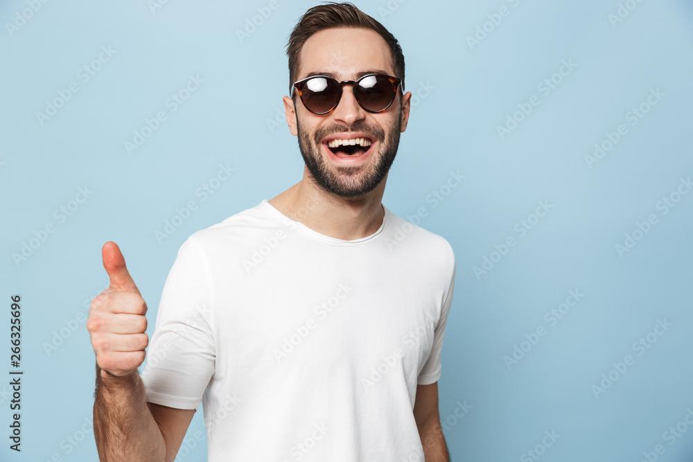 Cheerful excited man wearing blank t-shirt standing Cheerful excited man wearing blank t-shirt standing