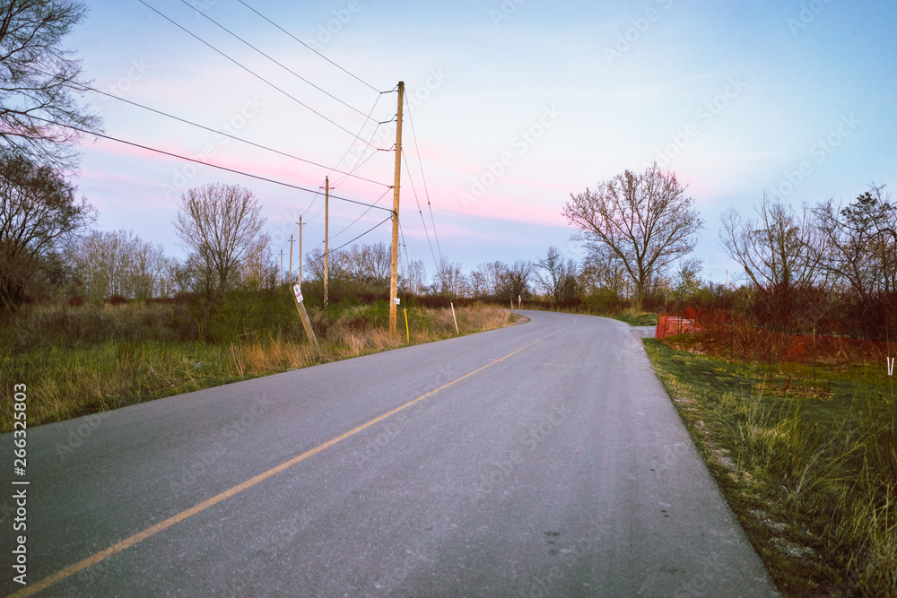 Lonely bend of a rural road at dusk Lonely bend of a rural road at dusk