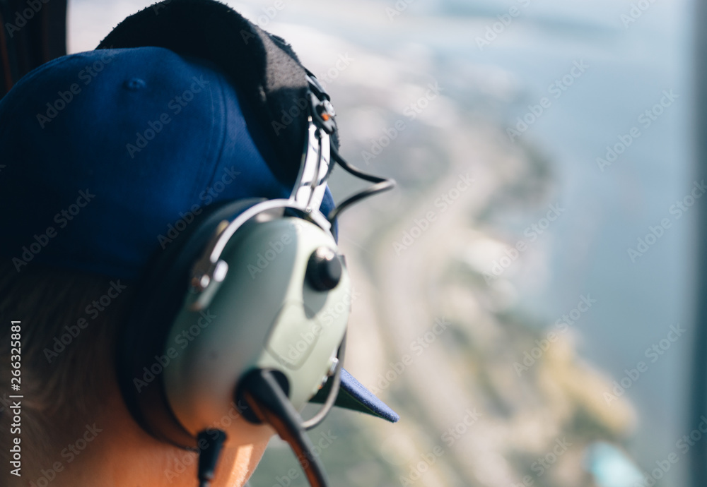 Fototapeta premium Man looks out of helicopter window