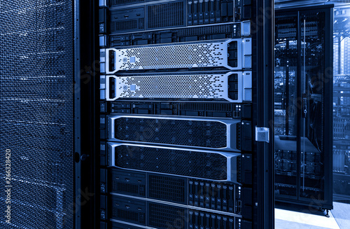 Server racks with mainframe disks cloud storage blue neon toning