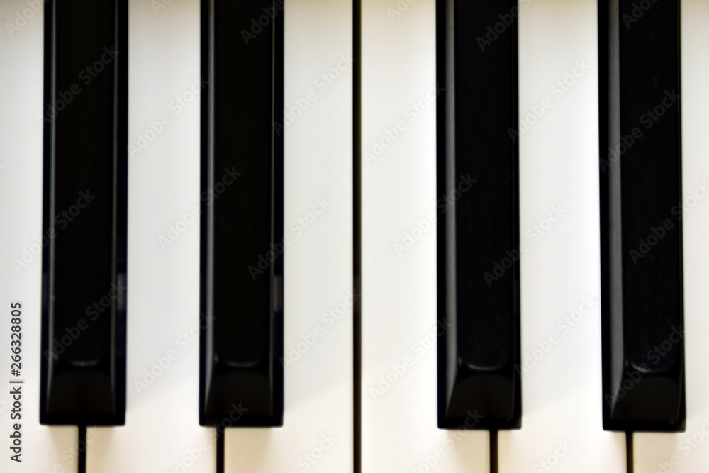 Naklejka premium Keys of a digital piano, soft focusing, creative mood of a person improvisation and creativity. Midi piano keyboard for playing digital music and making remixes.