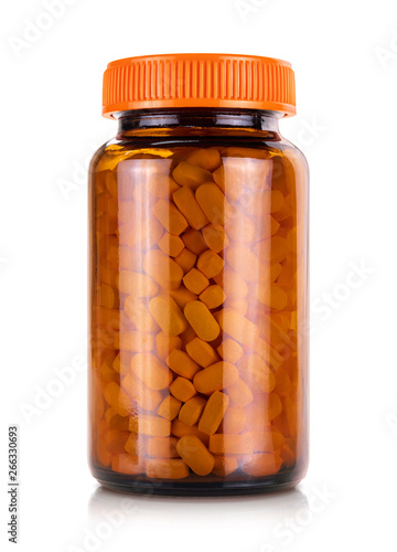 Brown glass bottle with vitamin or supplement product and orange cap isolated on white background