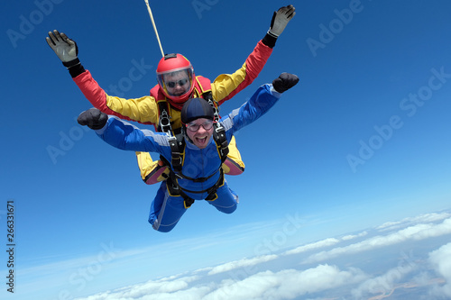 Skydiving. Tandem jump. Happy passenger and his instructor. photo