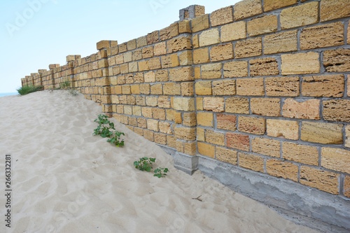 House protection from sand with shellstone limestone or Coquina Stone  wall fence. Coquina Stone   Coral Stone Fence.