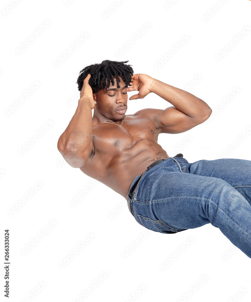 Fototapeta premium Young African man sitting on floor doing push ups