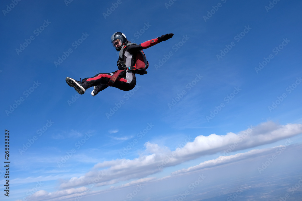 Skydiving. Girl is dancing in the sky.