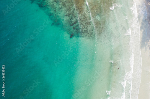 Aerial view, tropical beach, top view of the waves on the beautiful sand beach