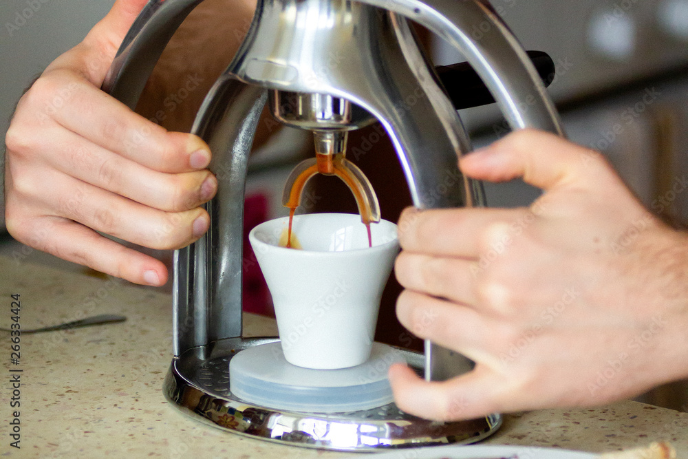 Men’s hands are making coffee in the morning, healthy breakfast. Closeup. Alternative coffee machine.