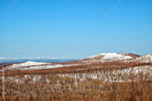 Winter mountain landscape with clear blue sky