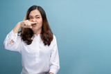 Woman wipe her nose and standing isolated over background