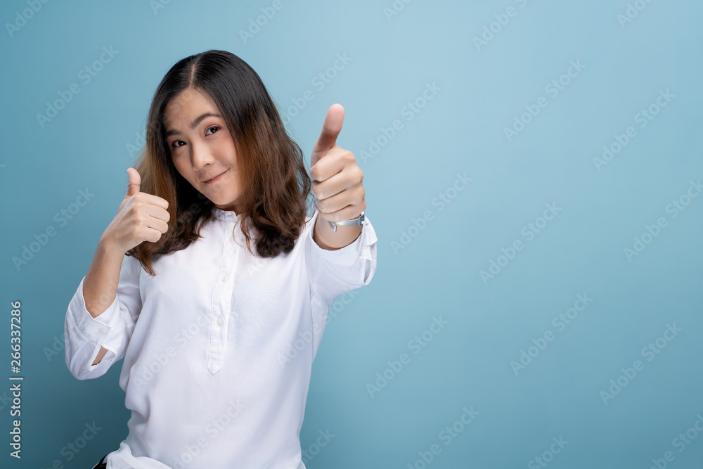 Happy woman showing thumb up isolated on background Happy woman showing thumb up isolated on background