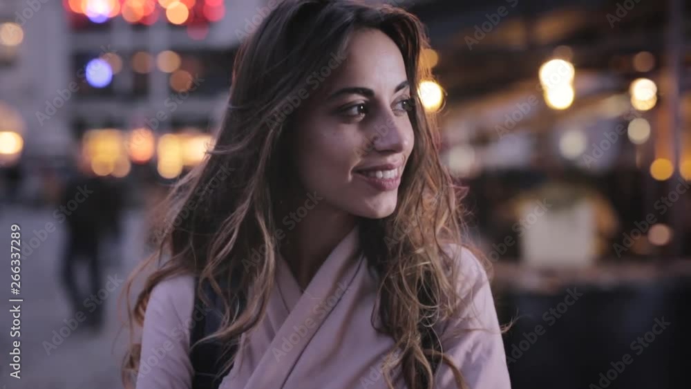 Attractive elegant Woman Looks at side from Camera And Smiling. closeup evening city portrait with lights. Attractive elegant Woman Looks at side from Camera And Smiling. closeup evening city portrait with lights.
