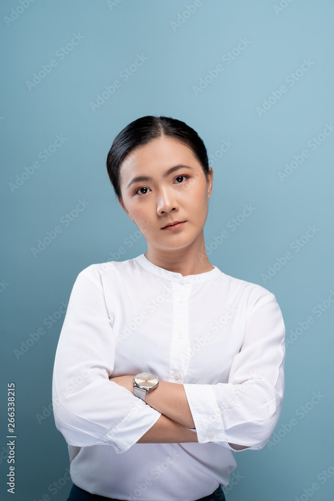Portrait of a confident woman standing isolated over background