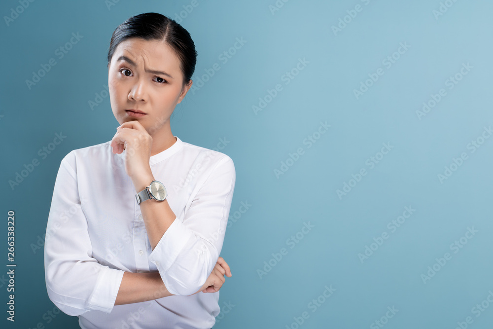 Woman feel confused isolated over blue background Woman feel confused isolated over blue background