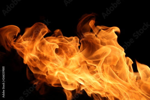 Fire burning on dark background for abstract flame texture and graphic design purpose