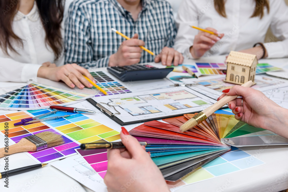 Group of creative designers working in office with color palettes Group of creative designers working in office with color palettes