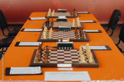 Chess pieces on a boart ready to play a game. Wood pieces of a game of chess on a board