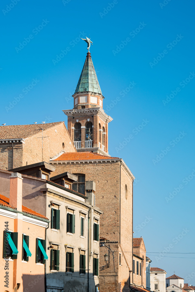 Fototapeta premium tower of San Giacomo church and houses in Chioggioa, Italy 